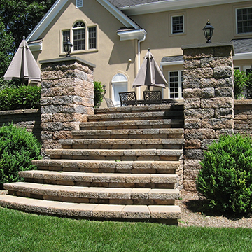 Large stone staircase leading from patio to yard